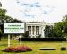 Billboard announcing 'CANNABIS RESCHEDULING REVIEW' on the lawn in front of the White House.